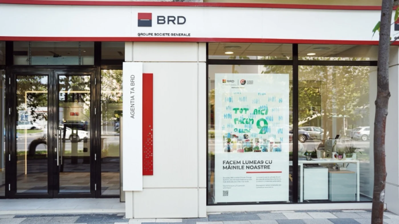 Lumea9 handmade sustainable communication campaign with artwork by Oana Barbonie displayed in a BRD branch window in Bucharest